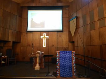 Pulpit with Ray's PowerPoint presentation projected on the wall behind it.